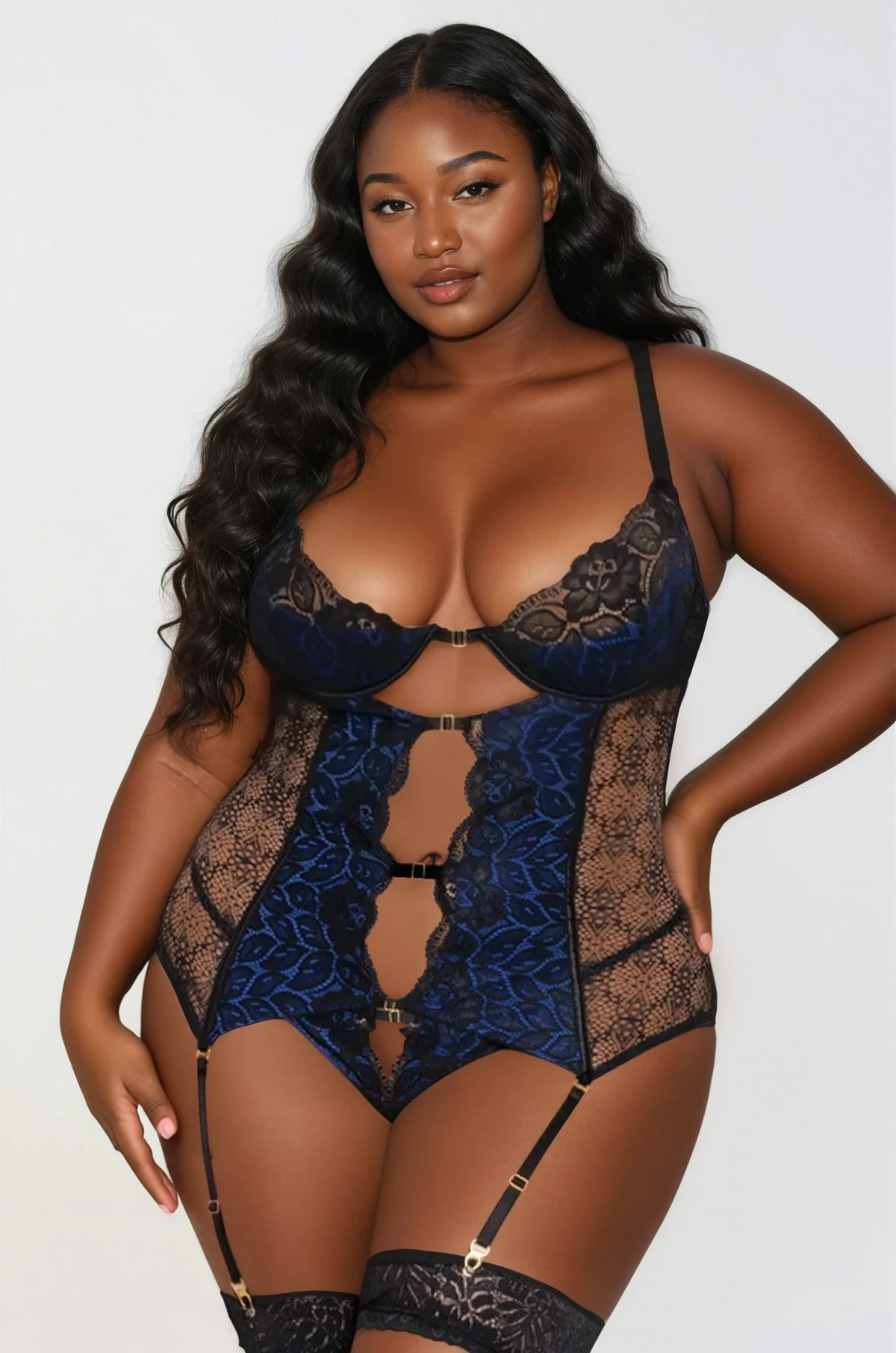 Plus size model wearing Sapphire Seduction Teddy in blue lace with black mesh and gold strap accents – Curvy Bombshells