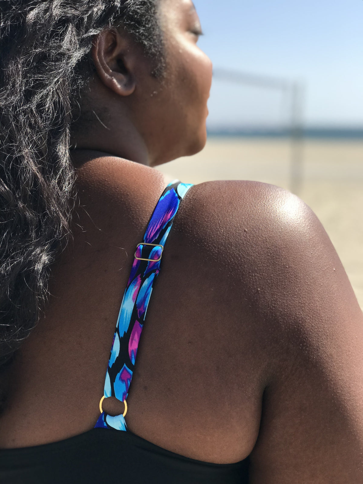 Close-up of fabric texture and strap design details on the plus-size Black Oasis Plunging One-Piece Swimsuit.