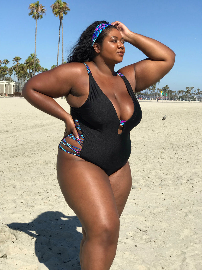 Plus-size model wearing Black Oasis Plunging One-Piece Swimsuit, designed to enhance curves and offer confidence, comfort, and style..